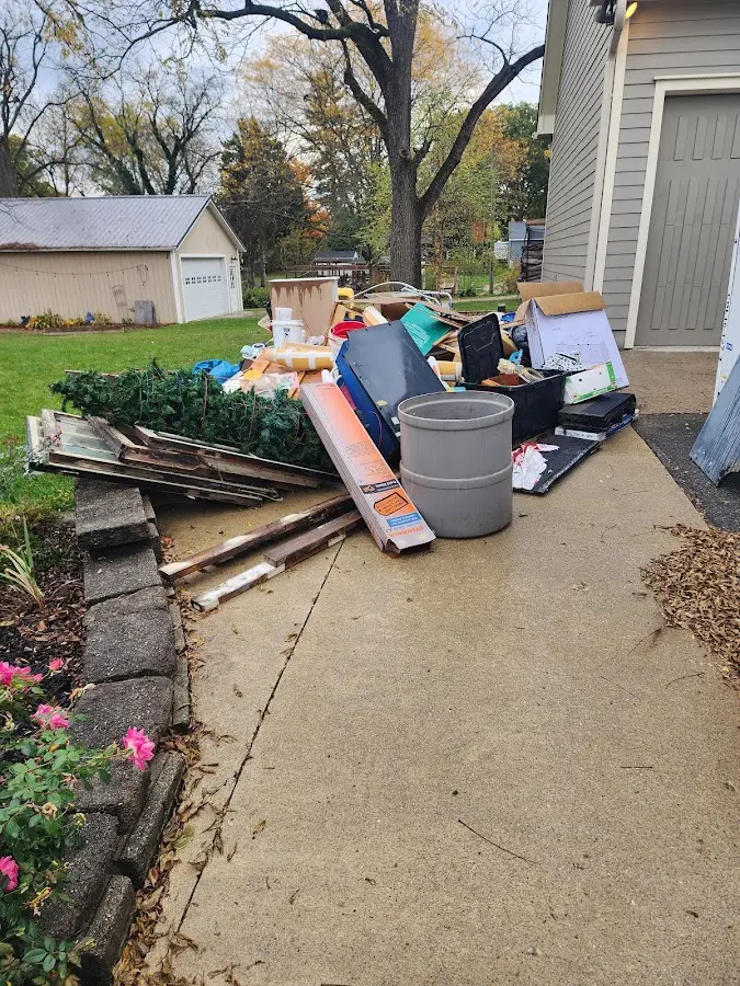 Dumpster being loaded with debris for Estate Cleanout Dumpster Rental in Robinwood